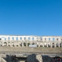 The Arena is the only remaining Roman amphitheatre to have four side towers and with all three Roman architectural orders entirely preserved. It was constructed in 27 BC - 68 AD and is among the six largest surviving Roman arenas in the World. A rare example among the 200 Roman surviving amphitheatres. The axes of the elliptical amphitheatre are 132.45 and 105.10 m long, and the walls stand 32.45 m high. It could accommodate 23,000 spectators in the cavea, which had forty steps divided into two meniani. The seats rest directly on the sloping ground; The field for the games, the proper arena, measured 67.95 by 41.65 m. The field was separated from the public by iron gates.